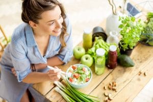 Woman happily eating a healthy meal.