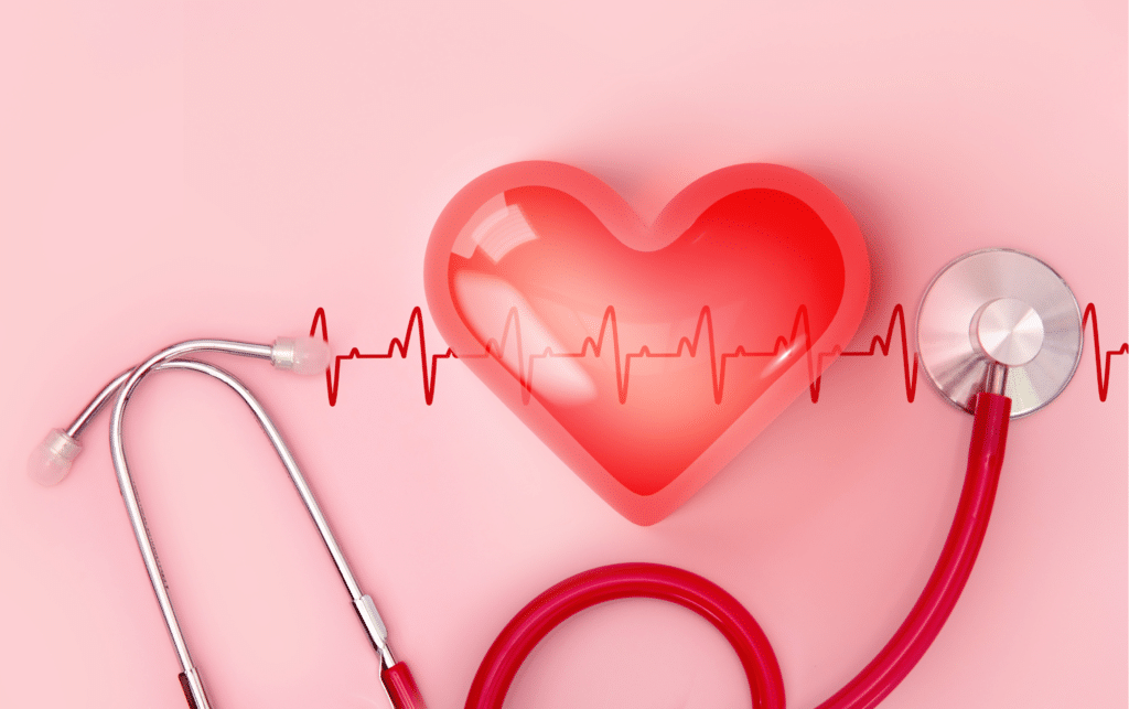 Red heart shape with line of cardio gram and stethoscope on pink background.