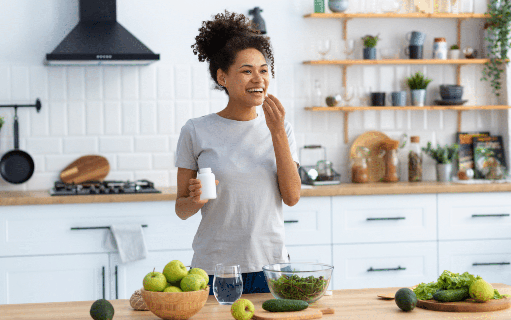 woman standing at the kitchen table taking weight loss medication