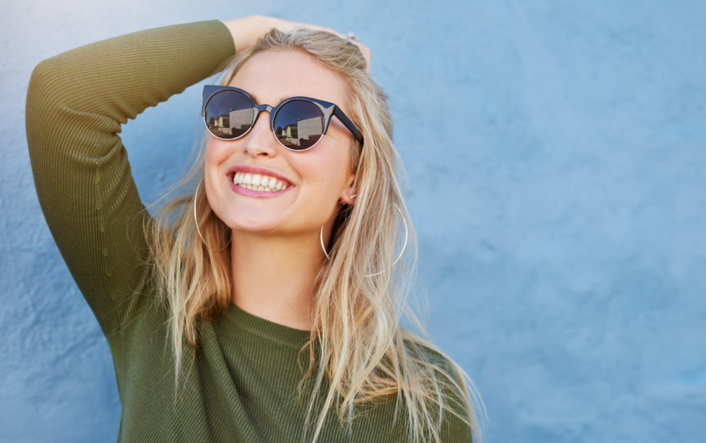 Young girl smiling with sunglasses on