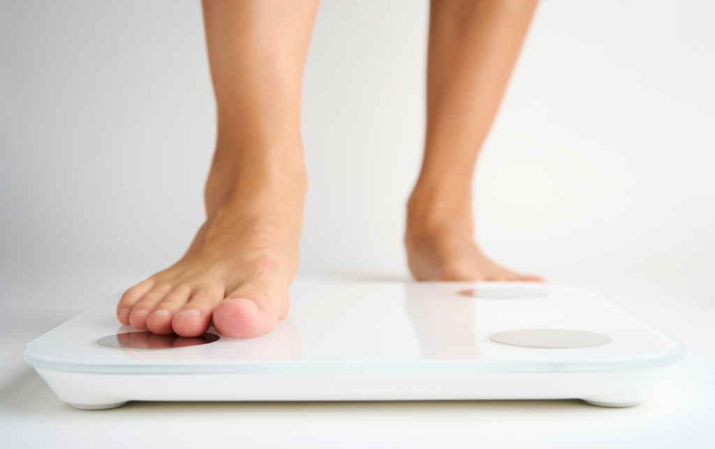 A woman steps on the scale